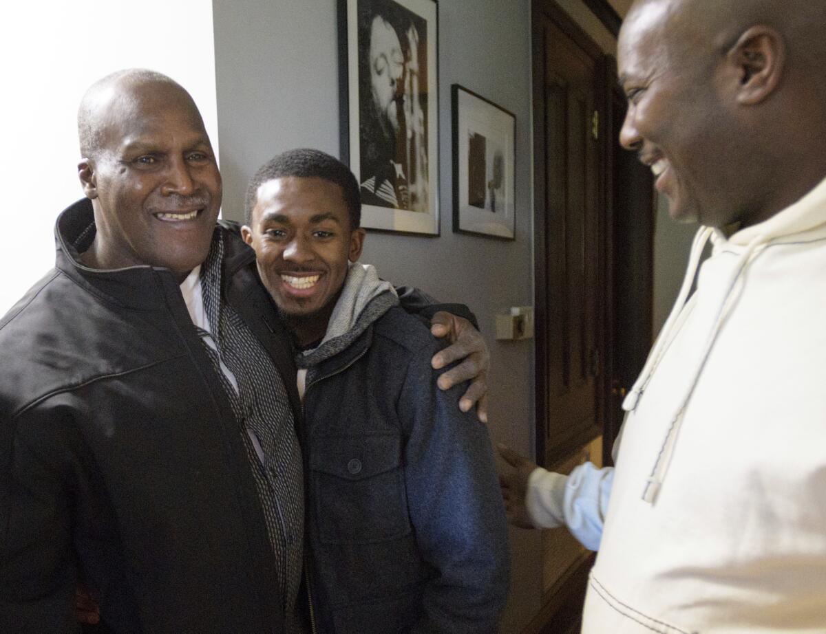 FILE - Malcolm Alexander, left, 58, was roughly the same age as his grandson son Malcolm Stewart, Jr., 20, center, next to his son Malcolm Stewart before a press conference shortly after his release in New Orleans, La., on Jan. 30, 2018. Alexander, a Louisiana man imprisoned for nearly four decades until conviction in a 1979 rape was thrown out in 2018, is now fighting for compensation for being wrongfully convicted. The Times-Picayune/The New Orleans Advocate reports that attorneys for Alexander took his argument for compensation to a state appeals court on Thursday, Sept. 8, 2022. (Matthew Hinton/The Times-Picayune/The New Orleans Advocate via AP)