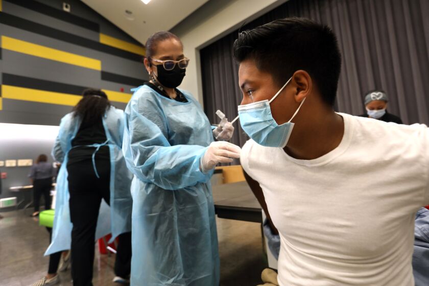 D’Marco Ahumada, age 16, gets his first vaccine at San Pedro High School