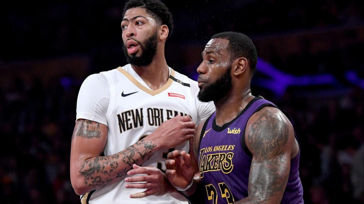 Lakers' LeBron James and New Orleans Pelicans' Anthony Davis defend each other during a 112-104 Laker win at Staples Center on Friday.