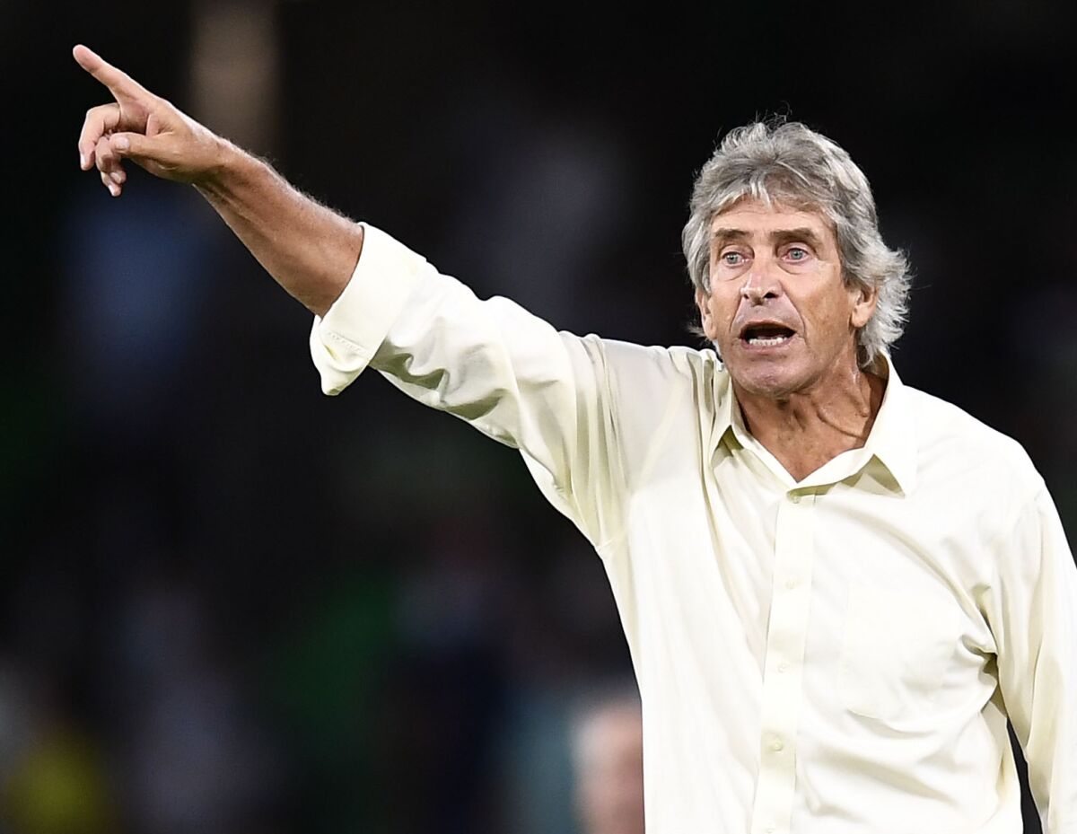 FILE - Betis' head coach Manuel Pellegrini gives instructions to his players during the Spanish La Liga soccer match between Real Betis and Real Madrid at Benito Villamarin stadium in Seville, Spain, Aug. 28, 2021. Being a fan of Spanish club Real Betis fan wasn’t much fun not long ago. Then came coach Manuel Pellegrini, and it didn’t take long before Betis’ fans started having reason to cheer again. Betis visits Rayo Vallecano in the first leg of the Copa semifinals on Wednesday Feb. 9, 2022, looking to return to the final for the first time since it won its last title in any competition in 2005. (AP Photo/Jose Breton, File)