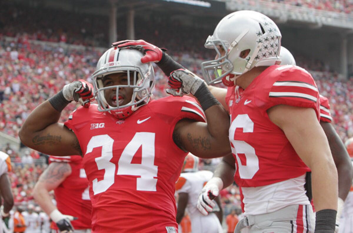 Ohio State running back Carlos Hyde (34) celebrates his touchdown against Florida A&M; with teammate Jeff Heuerman in the first quarter Saturday.