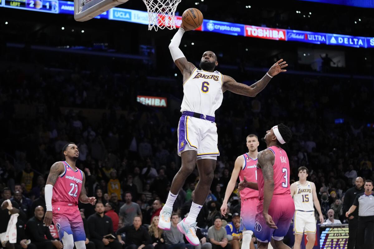 Lakers star LeBron James dunks during the second half of the Lakers' 119-117 win over the Washington Wizards.