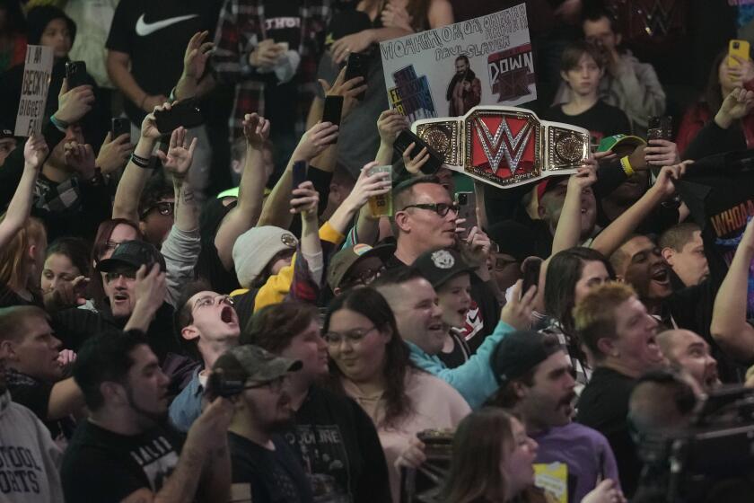 Wrestling fans during the WWE Monday Night RAW event, Monday, March 6, 2023, in Boston. (AP Photo/Charles Krupa)