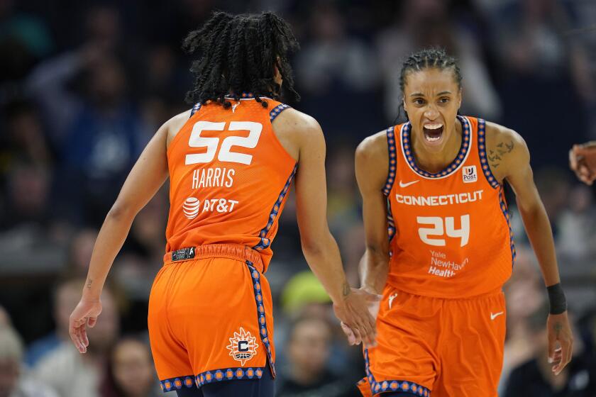 Connecticut Sun forward DeWanna Bonner (24) celebrates toward guard Tyasha Harris (52) after Harris made a three-point basket during the second half of Game 3 of a WNBA first-round basketball playoff series against the Minnesota Lynx, Wednesday, Sept. 20, 2023, in Minneapolis. (AP Photo/Abbie Parr)