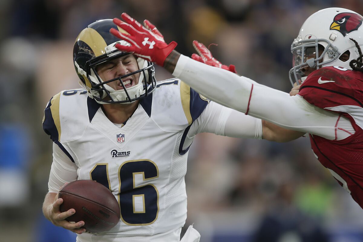 Rams quarterback Jared Goff is sacked by the Cardinals' D.J. Swearinger during second-half action at the Coliseum on Jan. 1.