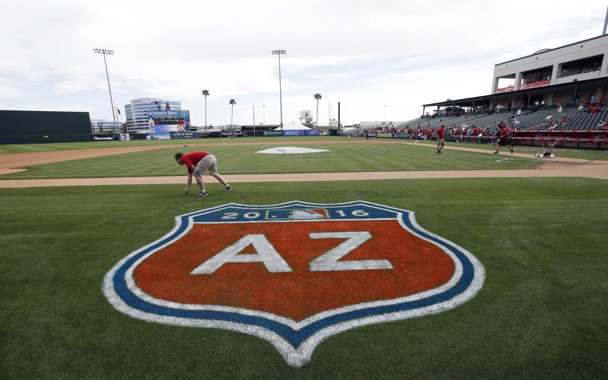 The grounds crew prepares for a spring training game at Tempe Diablo Stadium.