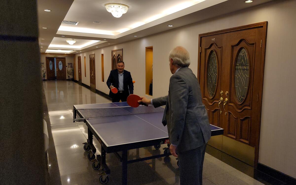 South Coast Plaza GM David Grant, right, plays a game of table tennis with Chinese Consul General in Los Angeles Zhang Ping.