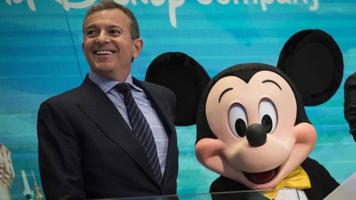 Disney Chief Executive Bob Iger and Mickey Mouse look on before ringing the opening bell at the New York Stock Exchange in November.