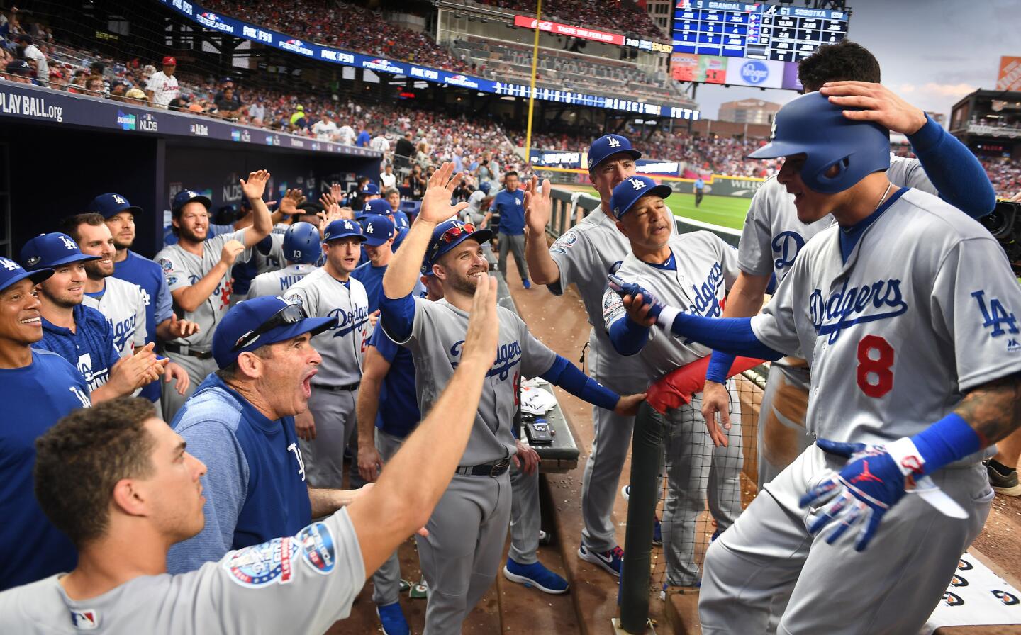 Dodgers shortstop Manny Machado is congratulated by teammates and coaches after hitting a three-run home run in the seventh inning.