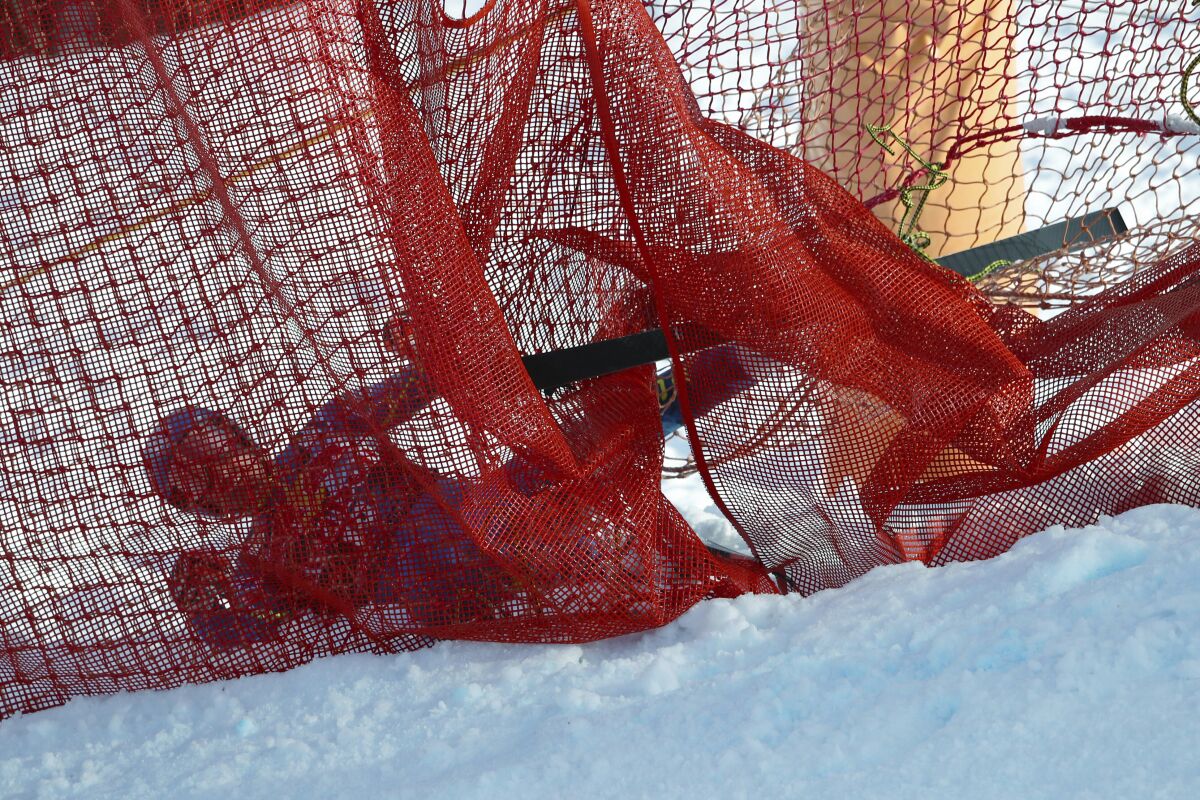 Skier Ryan Cochran-Siegle is entangled in safety netting.