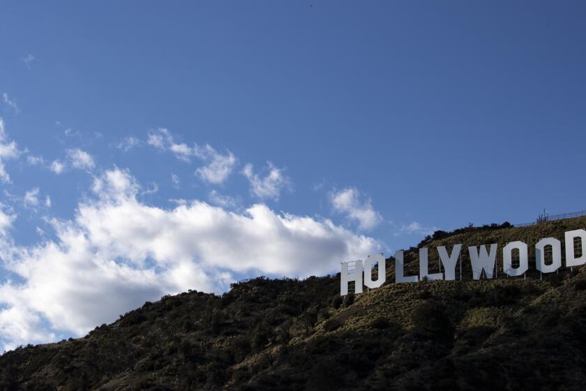 LOS ANGELES, CALIF. -- FRIDAY, MARCH 27, 2020: Clouds drift over the Hollywood sign in Griffith Park in Los Angeles, Calif., on March 27, 2020. (Brian van der Brug / Los Angeles Times)
