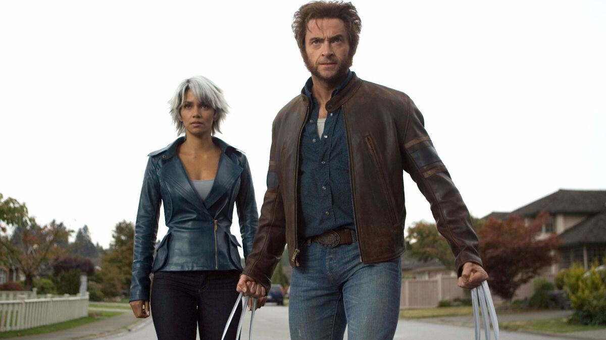 In this photo provided by Twentieth Century Fox, Storm (Halle Berry) and Wolverine (Hugh Jackman) prepare for battle in 'X Men: The Last Stand.' These and other Fox-owned characters could be added at Disney's theme parks.