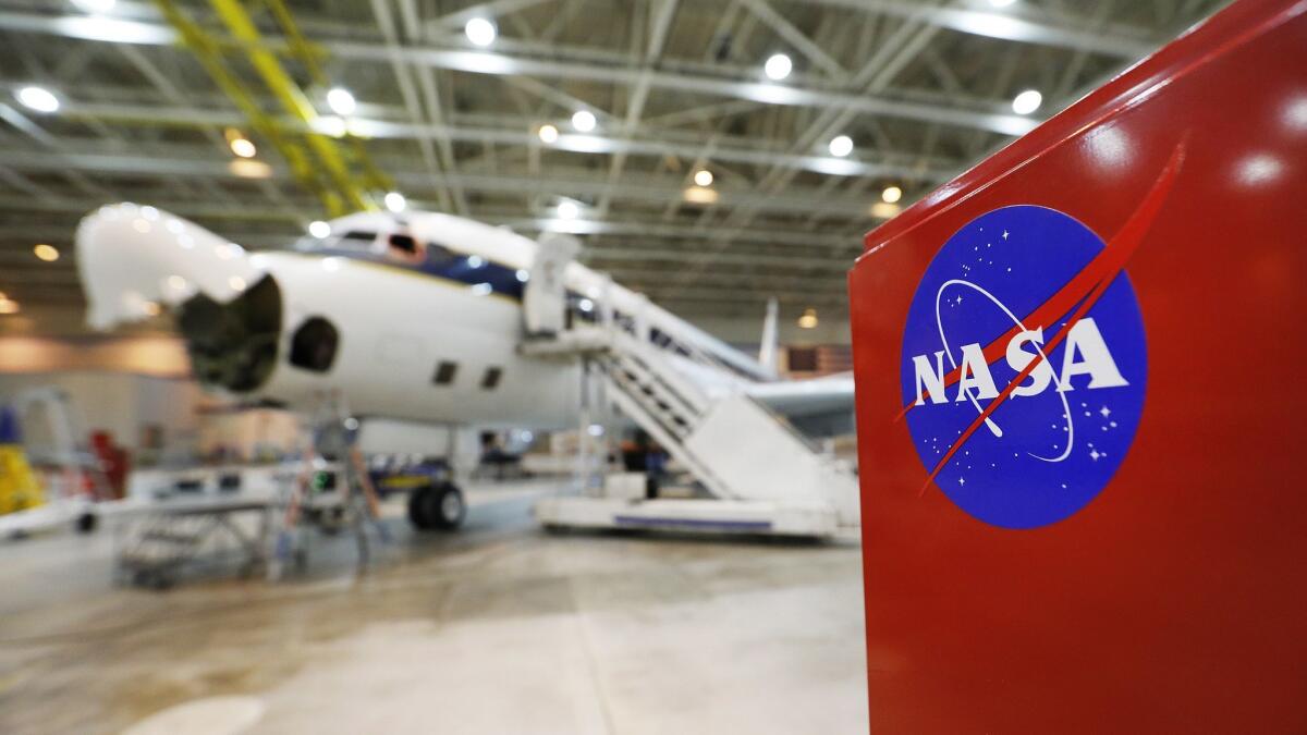 A NASA-operated DC-8 plane, which the agency uses to collect atmospheric samples, sits in its hangar in Palmdale. A House panel is investigating why the EPA denied use of the plane to monitor pollution in the Houston area after Hurricane Harvey.