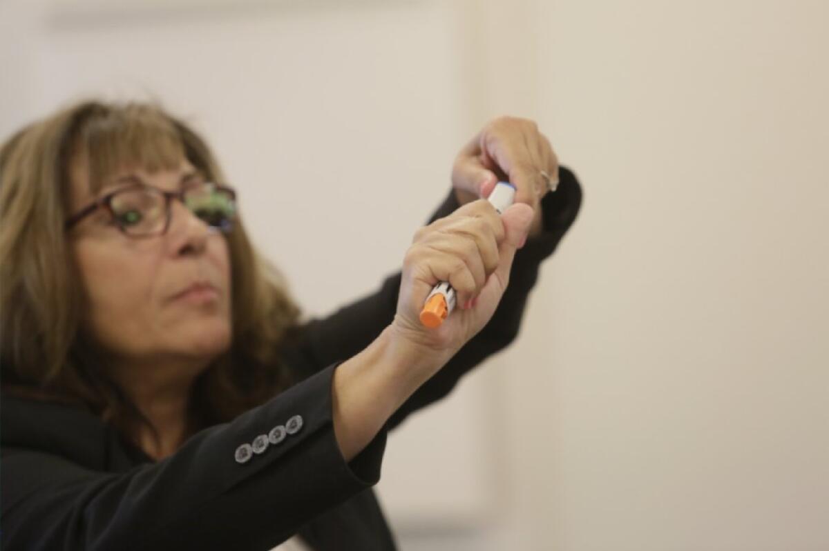 A trainer in the Michigan schools instructs teachers and other staff on how to use an epinephrine auto-injector. Michigan was ahead of California in stocking the life-saving devices in schools and training staff to use them in an emergency.