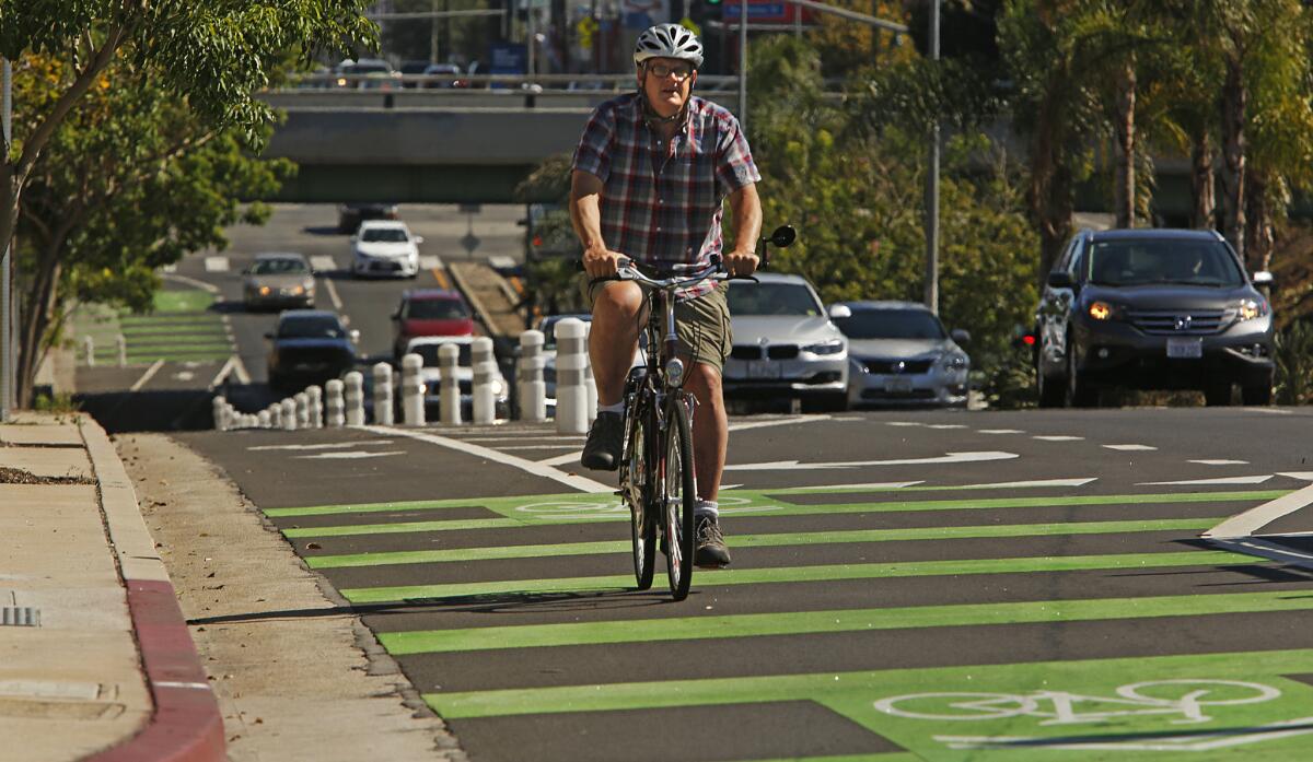 Brent Butterworth rides his bike on a protected bike lane on Reseda Boulevard in Northridge.