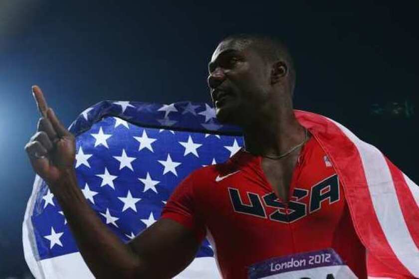Justin Gatlin celebrates winning a silver medal in the 400-meter relay at the 2012 London Games.
