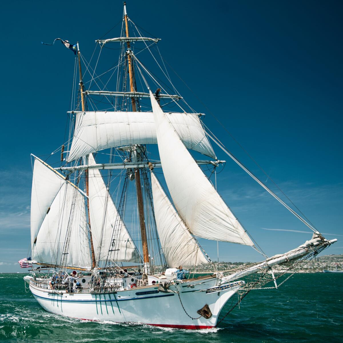 A tall ship with sails up
