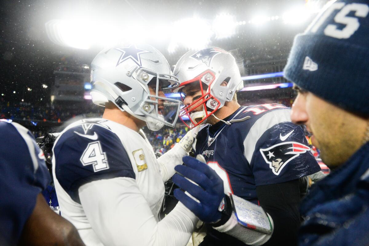 Dallas Cowboys quarterback Dak Prescott, left, shakes hands with New England Patriots quarterback Tom Brady after a game in November.