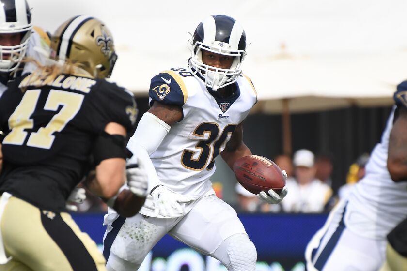 LOS ANGELES, CALIFORNIA SEPTEMBER 15, 2019-Rams runing back Todd Gurley looks ofr an opening against the Saints at the Coliseum Sunday. (Wally Skalij/Los Angeles Times)