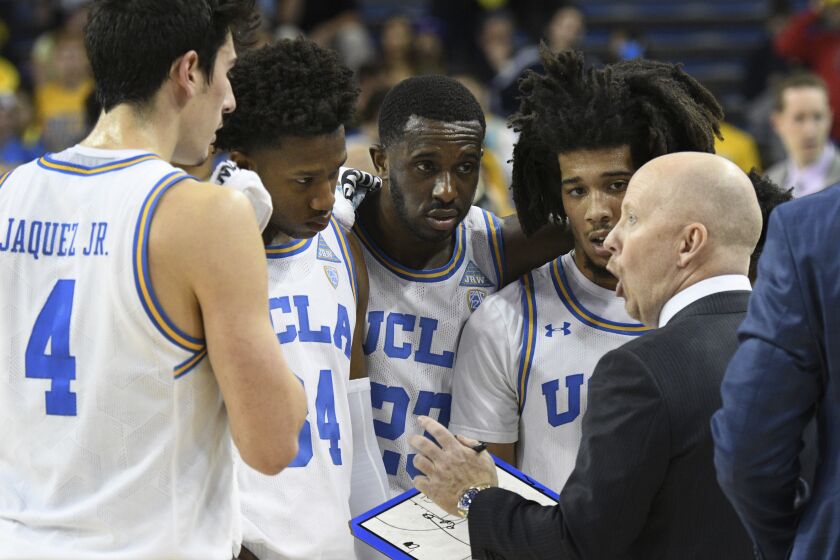 UCLA head coach Mick Cronin talks with Jaime Jaquez Jr., David Singleton, guard Prince Ali and Tyger Campbell, from left, during a timeout at an NCAA college basketball game against Colorado Thursday, Jan. 30, 2020, in Los Angeles. (AP Photo/Michael Owen Baker)