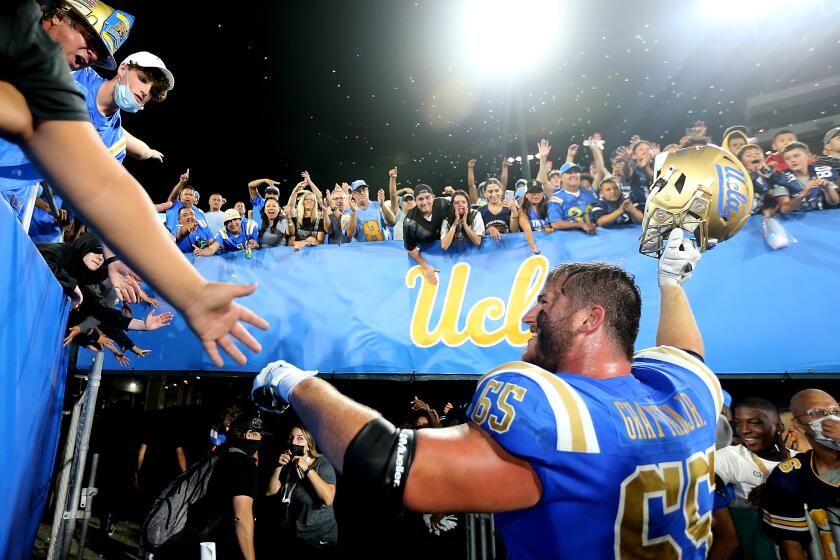 PASADENA, CALIF. - SEP. 4, 2021. Bruins starting left guard Paul Grattan is cheered by fans after UCLA beat LSU, 38-27, at the Rose Bowl on Saturday, Sept. 1, 2021. (Luis Sinco / Los Angeles Times)