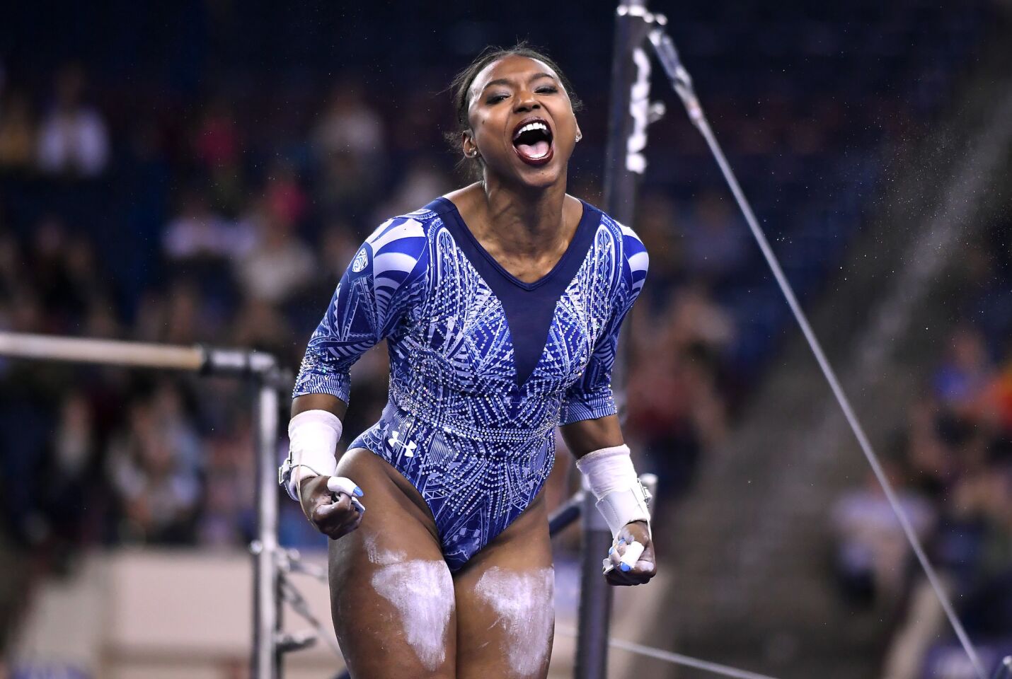 Nia Dennis celebrates after finising on the bars at the NCAA semifinals at the Ft. Worth Convention Center.