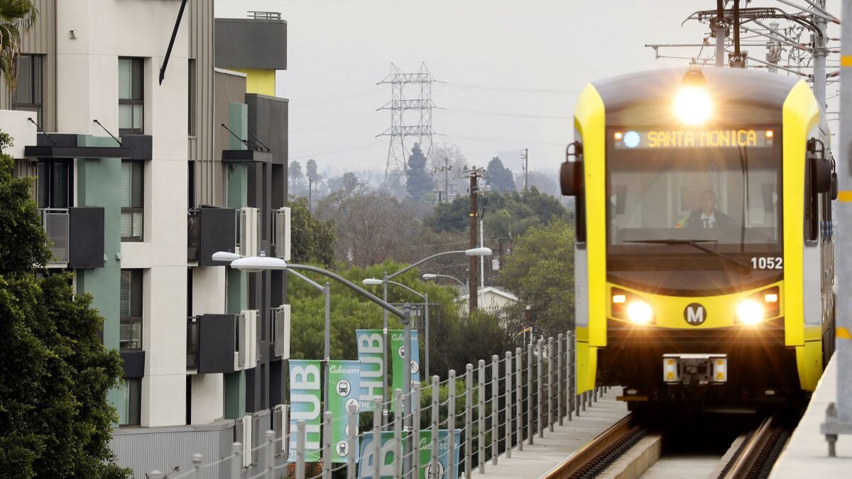 A Metro Expo Line train passes by apartments in Culver City in 2017.