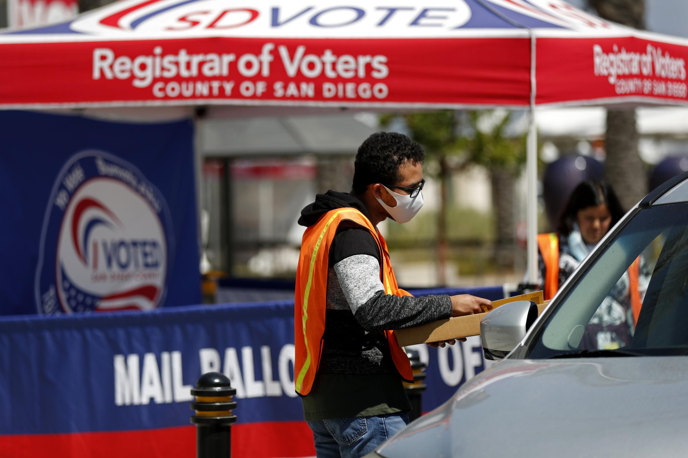 Anthony Alvarez collects recall ballots from voters dropping them off at the San Diego County Registrar of Voters