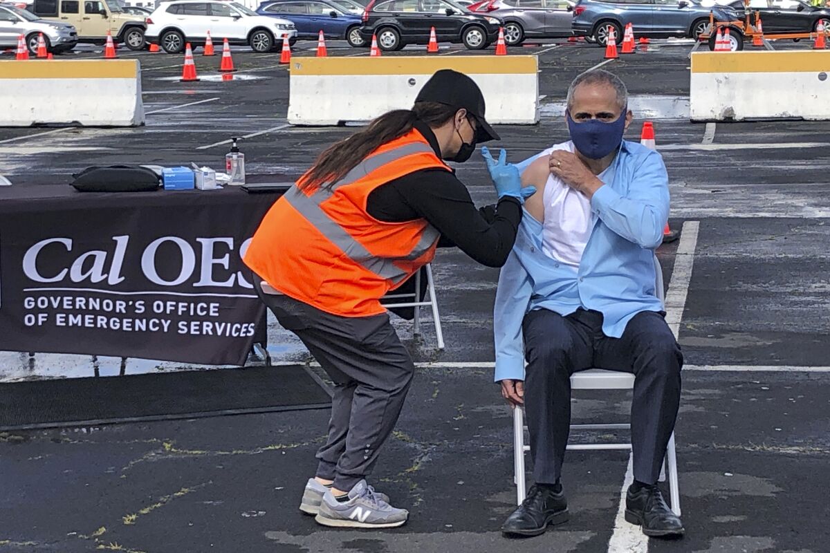 A man receives a COVID-19 vaccine