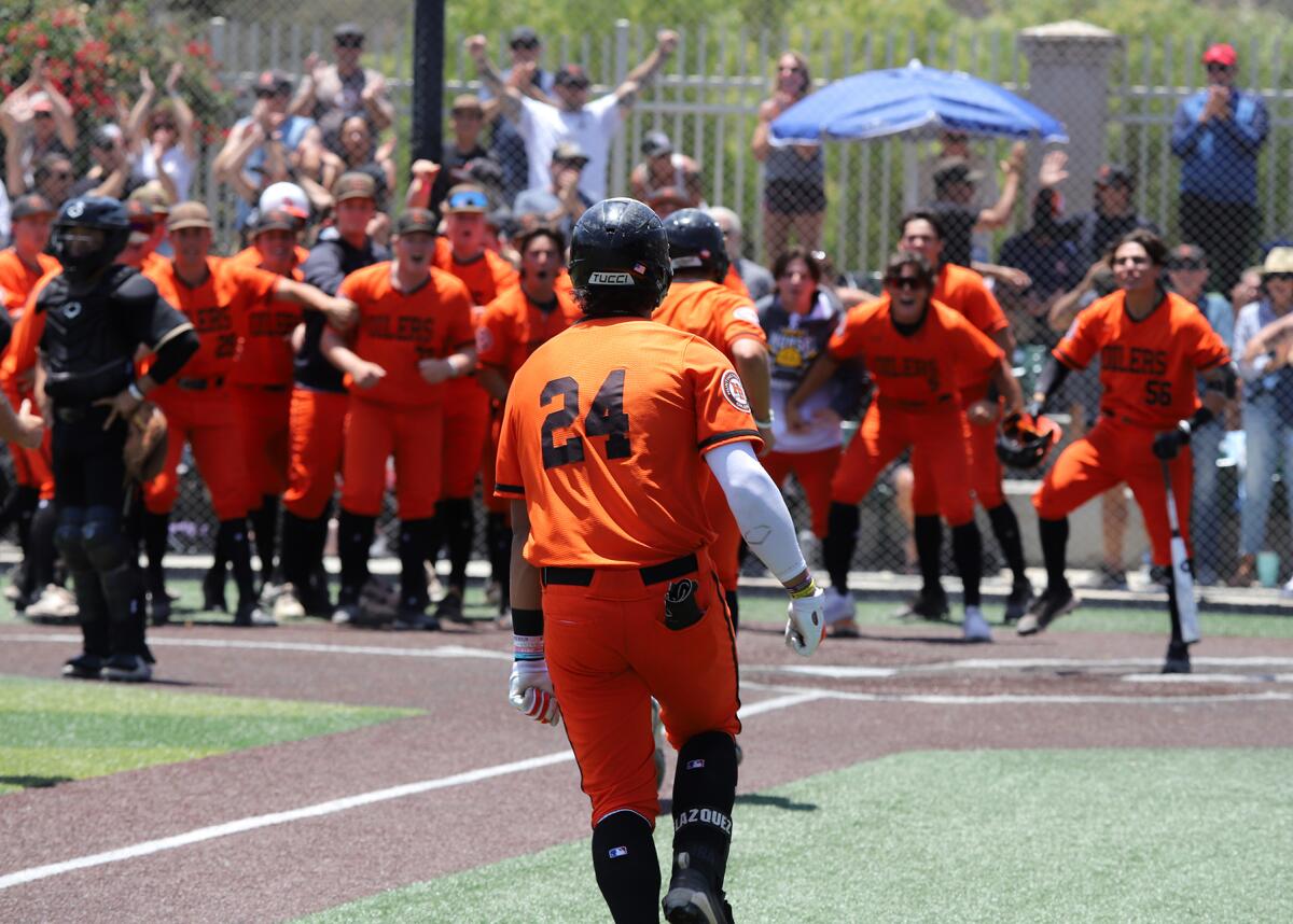 Huntington Beach's Ralph Velazquez (24) runs to home after hitting a home run during extra innings at JSerra on Saturday