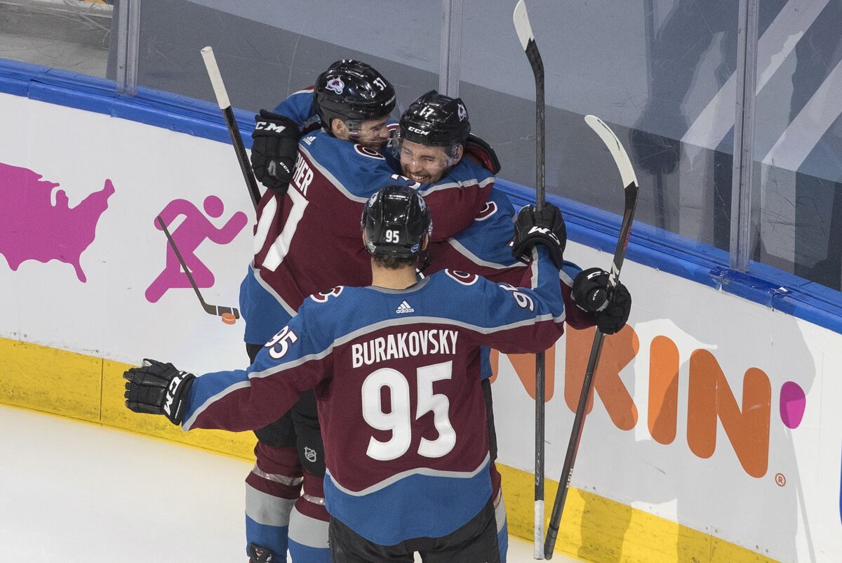 Colorado Avalanche' J.T. Compher (37), Tyson Jost (17) and Andre Burakovsky (95) celebrate a goal against the Arizona Coyotes during the second period of a first round NHL Stanley Cup playoff hockey series in Edmonton, Alberta, Friday, Aug. 14, 2020. (Jason Franson/The Canadian Press via AP)