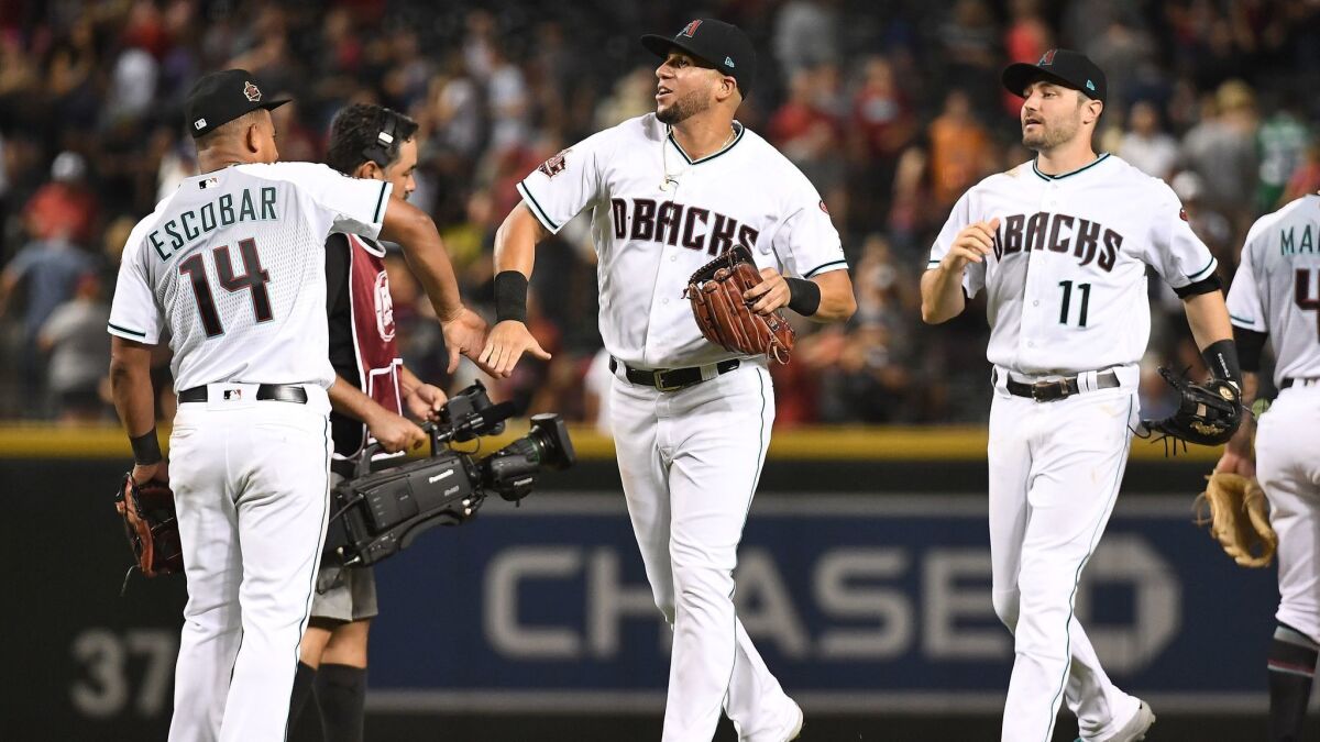 Arizona Diamondbacks players celebrate their win over the San Francisco Giants on Saturday. As of Sunday, both the Dodgers and Diamondbacks are tied at first in the NL West.