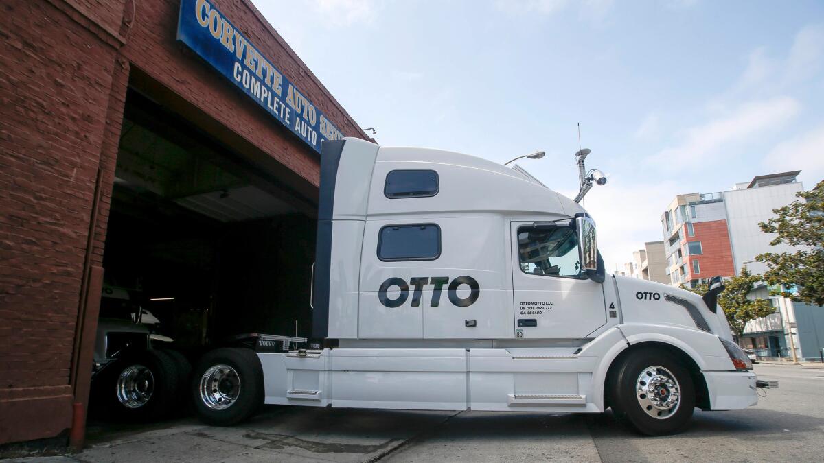 One of Otto's self-driving big-rig trucks leaves the garage during a demonstration at Otto headquarters in San Francisco.