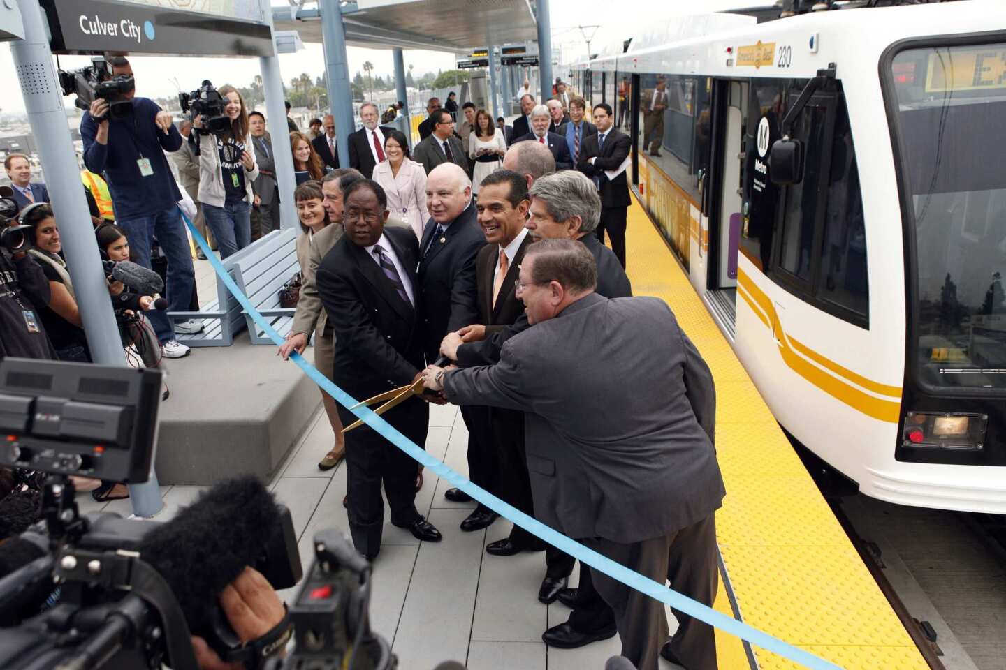 Mayor Antonio Villaraigosa poses for the ribbon-cutting to open the Culver City station.