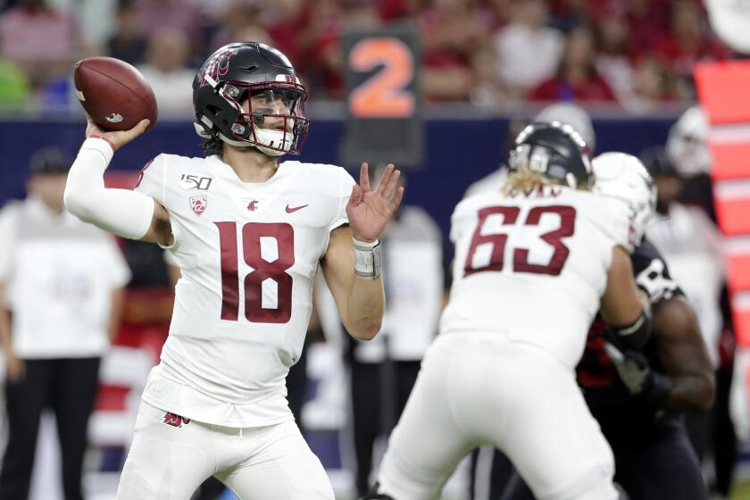 Washington State Cougars quarterback Anthony Gordon (18) throws a pass as offensive lineman Liam Ryan (63) blocks during the first half of an NCAA college football game against the Houston Cougars Friday, Sept. 13, 2019, in Houston. (AP Photo/Michael Wyke)