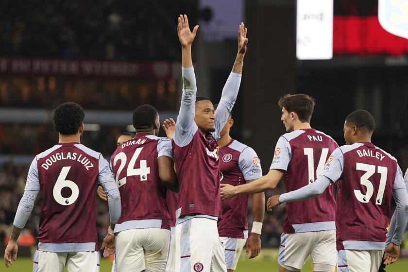 Aston Villa's scorer Ezri Konsa, front, and his teammates celebrate their side's second goal during the English Premier League soccer match between Aston Villa and Wolverhampton Wanderers in Birmingham, England, Saturday, March 30, 2024. (Bradley Collyer/PA via AP)