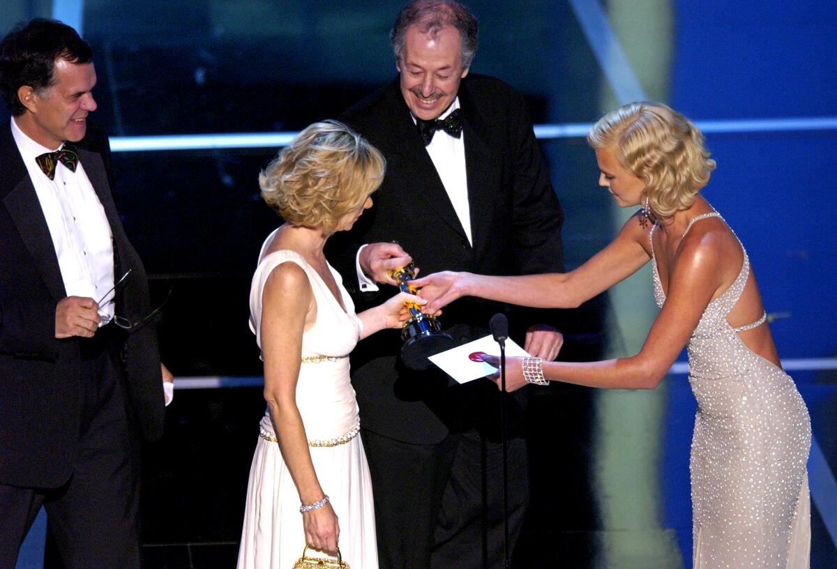 Charlize Theron presents the foreign language Oscar to two men and woman who took the stage.