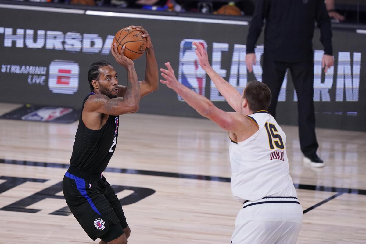 Clippers forward Kawhi Leonard shoots over Nuggets center Nikola Jokic during Game 7 on Sept. 15, 2020.