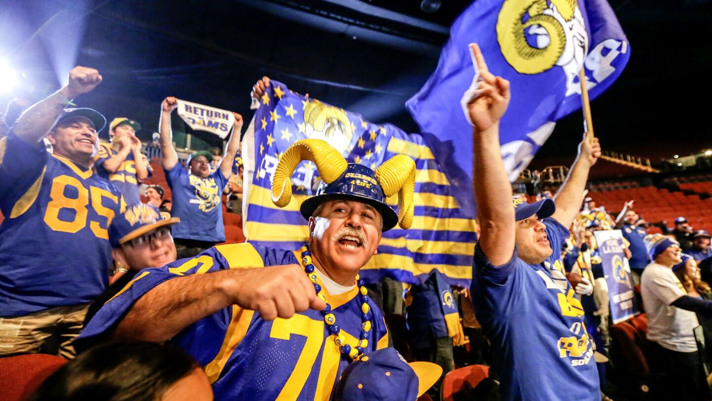 Rams fans cheer as team representatives hold a news conference at the Forum in Inglewood last Friday.