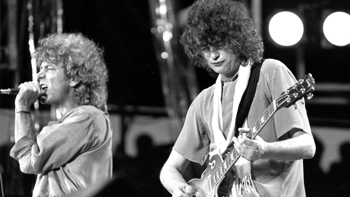 Singer Robert Plant, left, and guitarist Jimmy Page of the British rock band Led Zeppelin perform at the Live Aid concert at Philadelphia's J.F.K. Stadium on July 13, 1985.