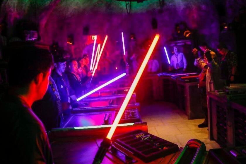 ANAHEIM, CA--MAY 29, 2019--Inside Savi's Workshop is lit up by lightsabers, where, for $215, visitors are guided in a lightsaber-building experience, in the new "Star Wars: Galaxy?s Edge" at Disneyland Resort, in Anaheim, CA, May 29, 2019. (Jay L. Clendenin / Los Angeles Times)