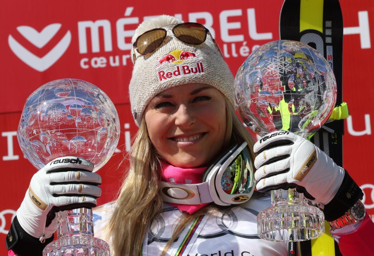 Lindsey Vonn celebrates on the podium at the World Cup finals in Meribel, France, in March.