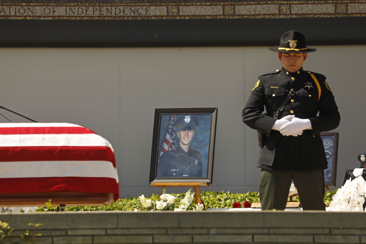 A picture of LAPD Officer Houston Tipping is displayed at his memorial