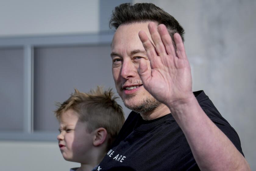 FILE - Tesla CEO Elon Musk waves as he leaves the Tesla Gigafactory for electric cars after a visit in Gruenheide near Berlin, Germany, March 13, 2024. After reporting dismal first-quarter sales, Tesla is planning to lay off about a tenth of its workforce as it tries to cut costs, multiple media outlets reported Monday. (AP Photo/Ebrahim Noroozi, File)