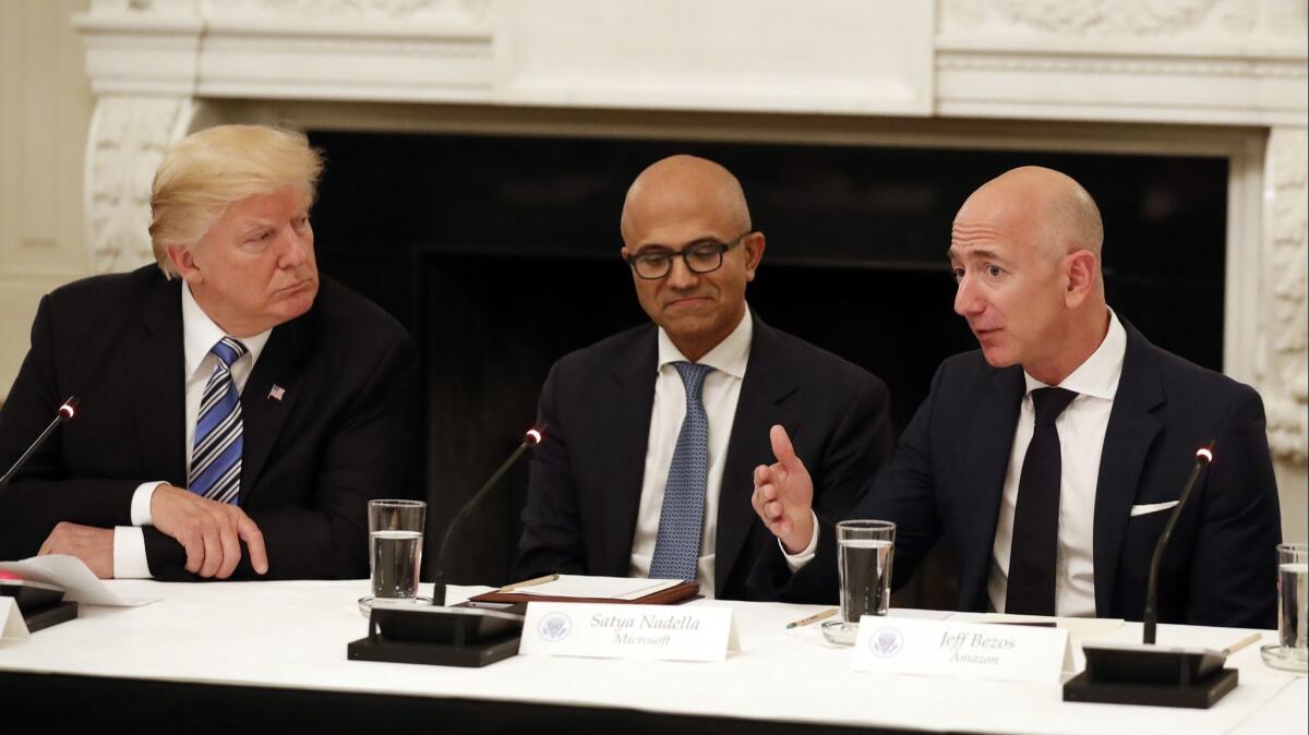 A White House technology roundtable in June with Microsoft CEO Satya Nadella, center, and Amazon CEO Jeff Bezos, right, and President Trump.