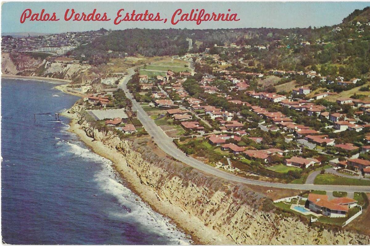 The Palos Verdes Estates coastline, on a vintage postcard, with rows of terracotta-roofed houses overlooking the ocean.