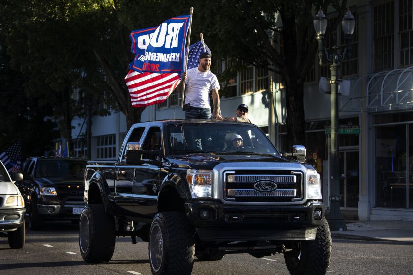 President Donald Trump supporters attend a rally and car parade Saturday, Aug. 29, 2020, from Clackamas to Portland, Ore. (AP Photo/Paula Bronstein)