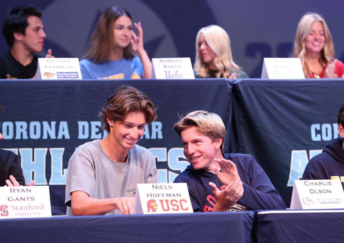 Niels Hoffmann (tennis, USC) and Charlie Olson (golf, Gonzaga University) from left, join others in a signing day event.