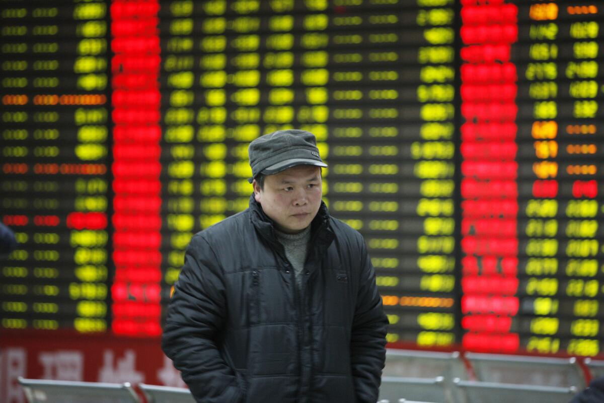 An investor observes stock market data in Huaibei, China.