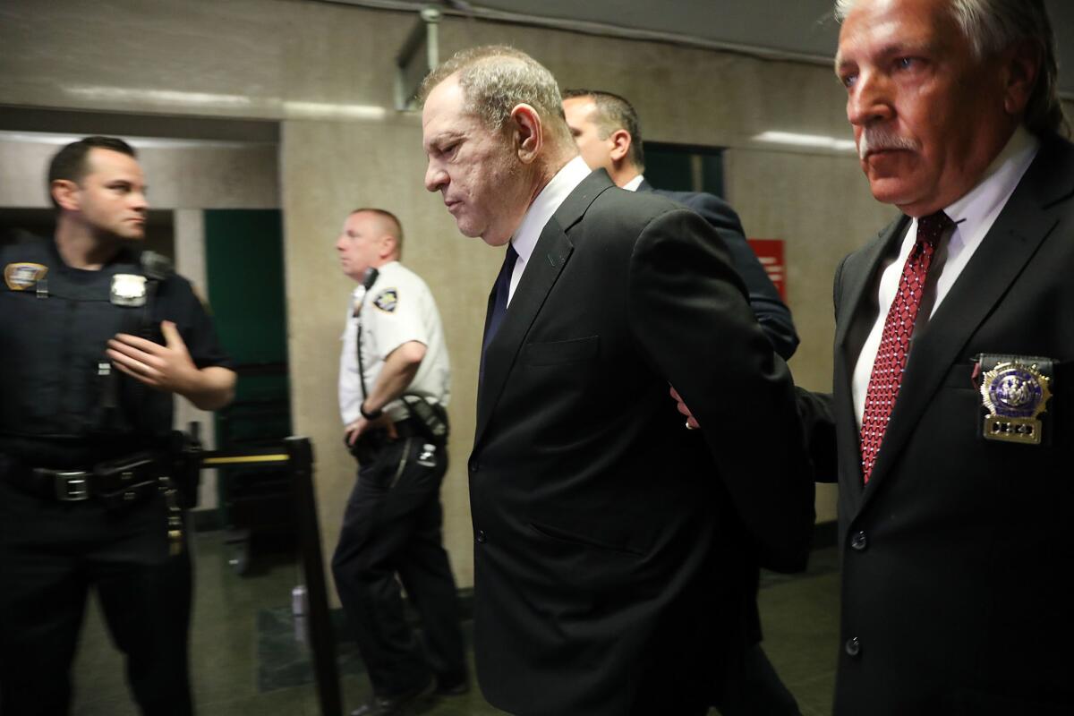Harvey Weinstein is escorted in handcuffs into State Supreme Court in July for arraignment on sex crime charges.